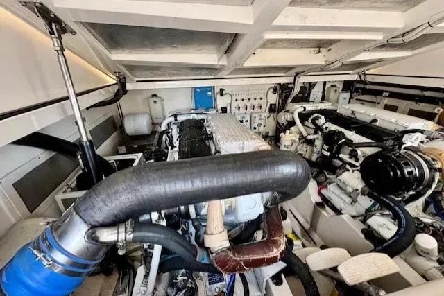 Slide: The Image of Engine room of a 2004 Cabo 40 Express boat, showcasing mechanical components and systems. - 20