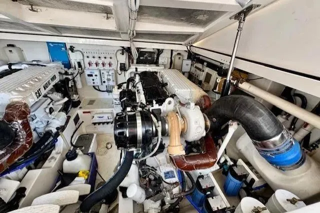 Slide: The Image of Engine room of a 2004 Cabo 40 Express boat, showcasing detailed mechanical components. - 18