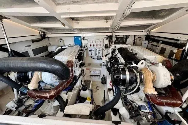 Slide: The Image of Engine room of a 2004 Cabo 40 Express boat, showcasing dual engines and mechanical components. - 19
