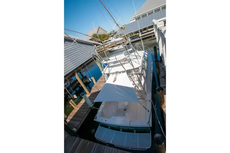 Slide: The Image of 2004 Cabo 40 Express yacht docked at marina, viewed from above. - 14