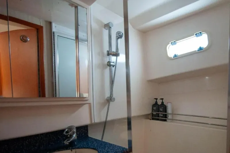 Slide: The Image of Bathroom interior of 2004 Cabo 40 Express yacht with shower and window. - 21