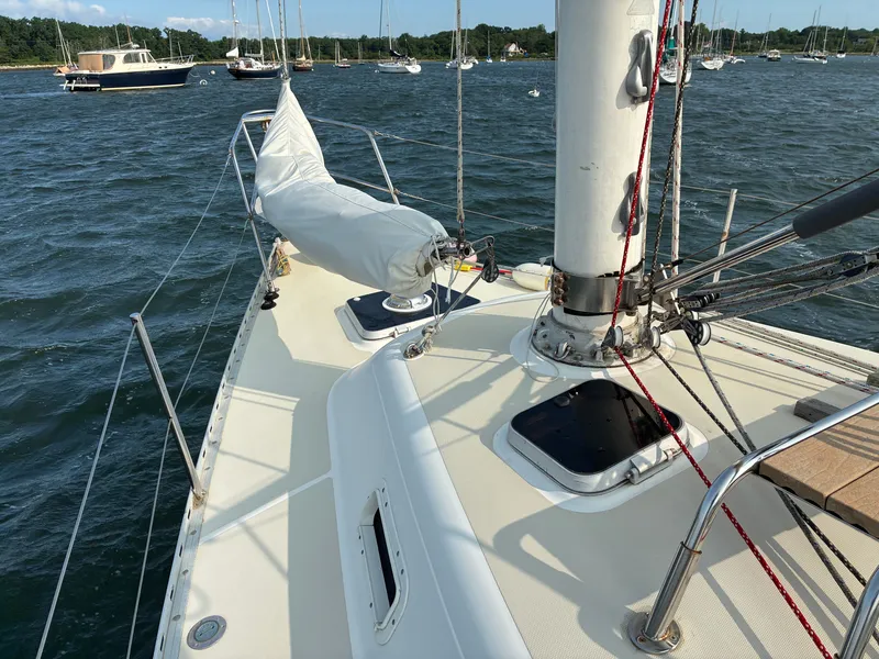 Slide: The Image of The deck of a 1986 Freedom Yachts 30 with sailboats in the background. - 13