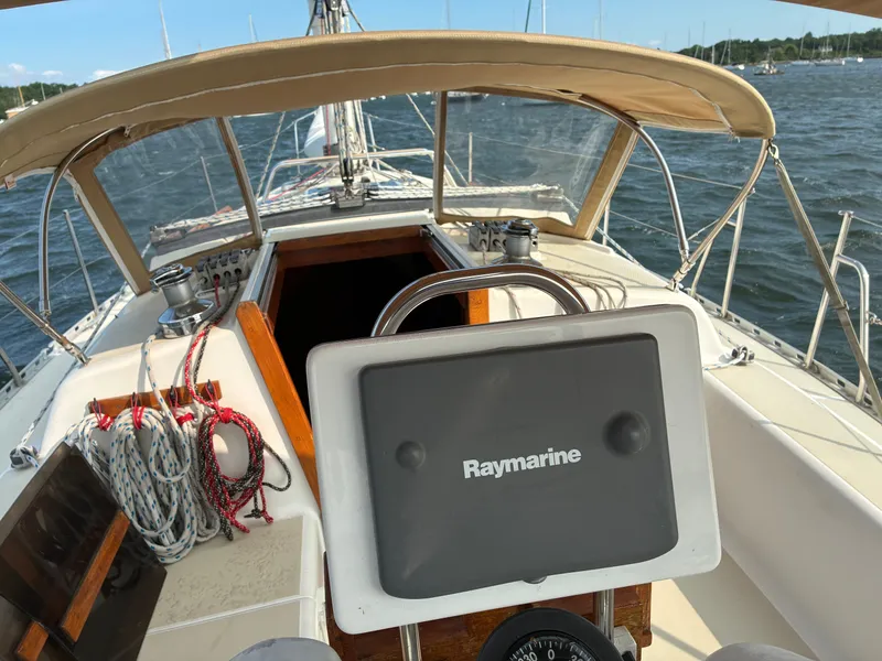 Slide: The Image of The cockpit of a 1986 Freedom Yachts 30 with Raymarine controls and sailing equipment. - 7
