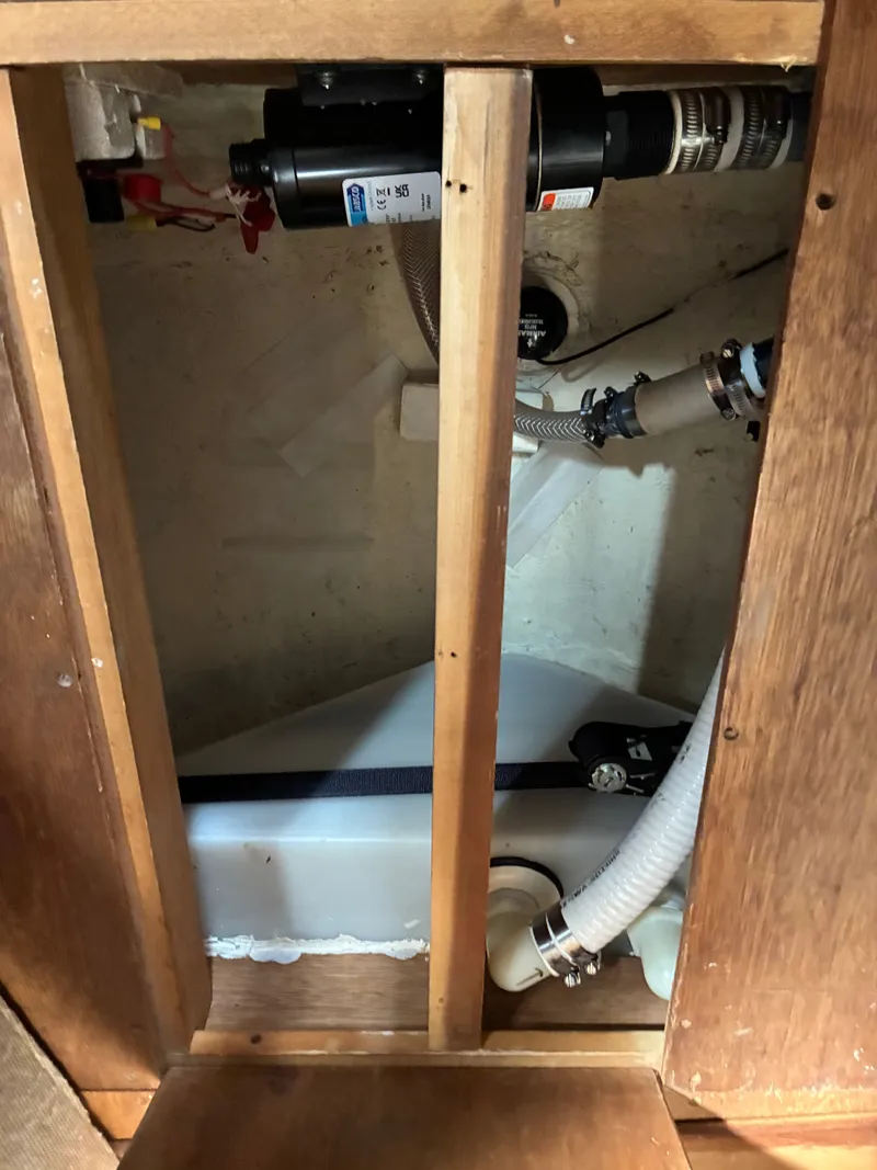 Slide: The Image of A view inside the engine compartment of a 1986 Freedom Yachts 30, showing hoses and fittings. - 40