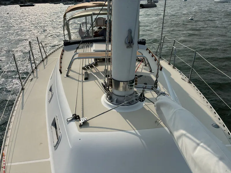Slide: The Image of The deck of a 1986 Freedom Yachts 30 with sail and rigging on calm water. - 16