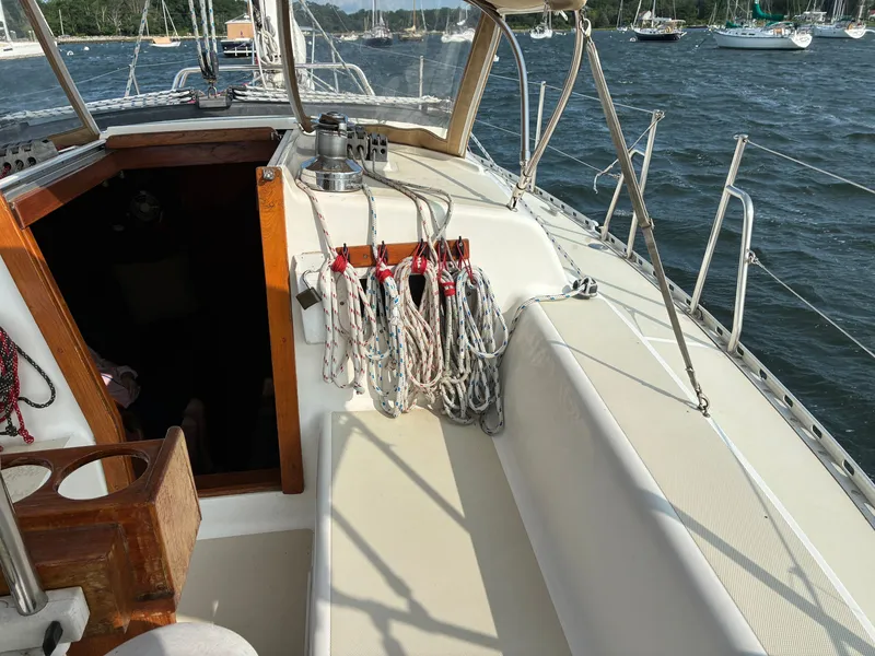 Slide: The Image of The cockpit of a 1986 Freedom Yachts 30 with ropes and an open companionway. - 10