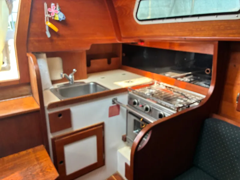 Slide: The Image of The galley of a 1986 Freedom Yachts 30 with a sink and stove. - 29