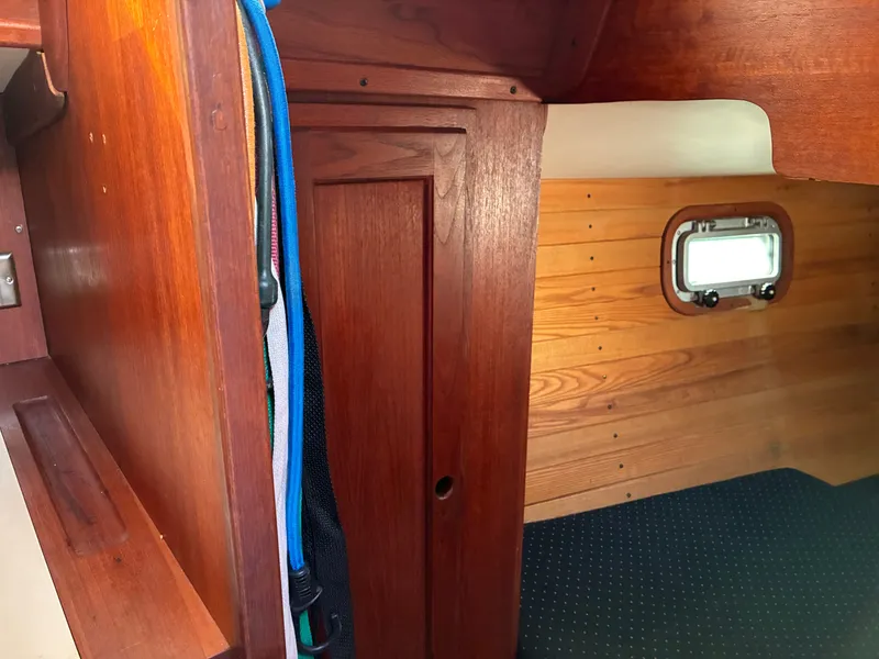 Slide: The Image of Interior of a 1986 Freedom Yachts 30 with wood paneling and a small window. - 35