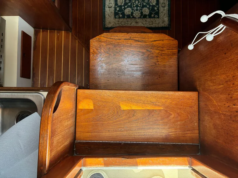 Slide: The Image of Interior of a 1986 Freedom Yachts 30 with wood paneling and a sink. - 22