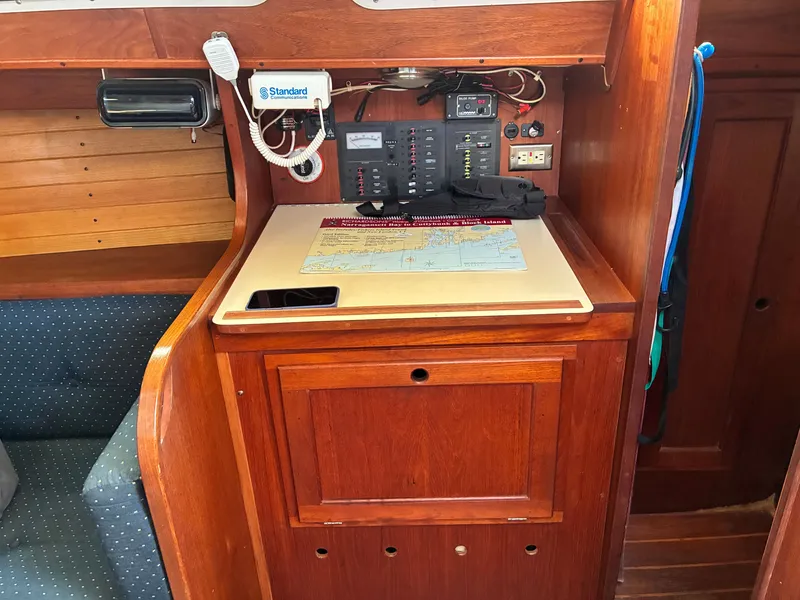 Slide: The Image of Interior view of a yacht with wooden cabinetry, navigation chart, and communication equipment. - 32