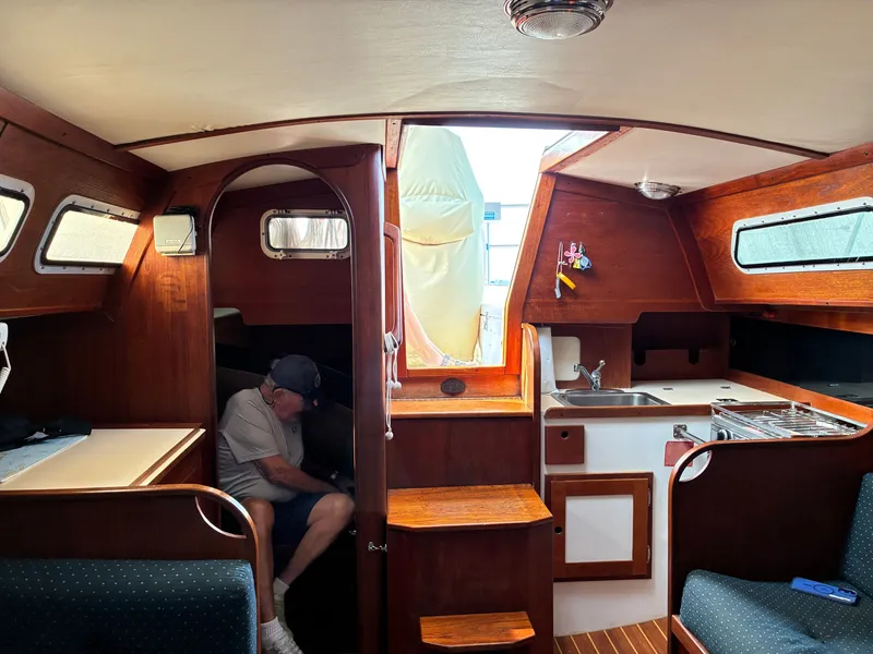 Slide: The Image of Interior of a 1986 Freedom Yachts 30 with wood finish and a small galley. - 24