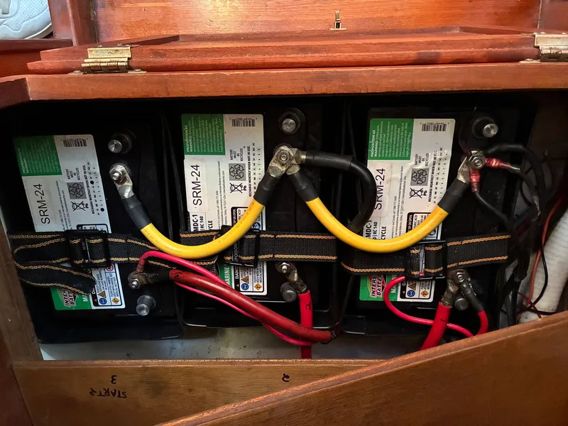 Slide: The Image of Three batteries are installed in a wooden compartment of a 1986 Freedom Yachts 30. - 43