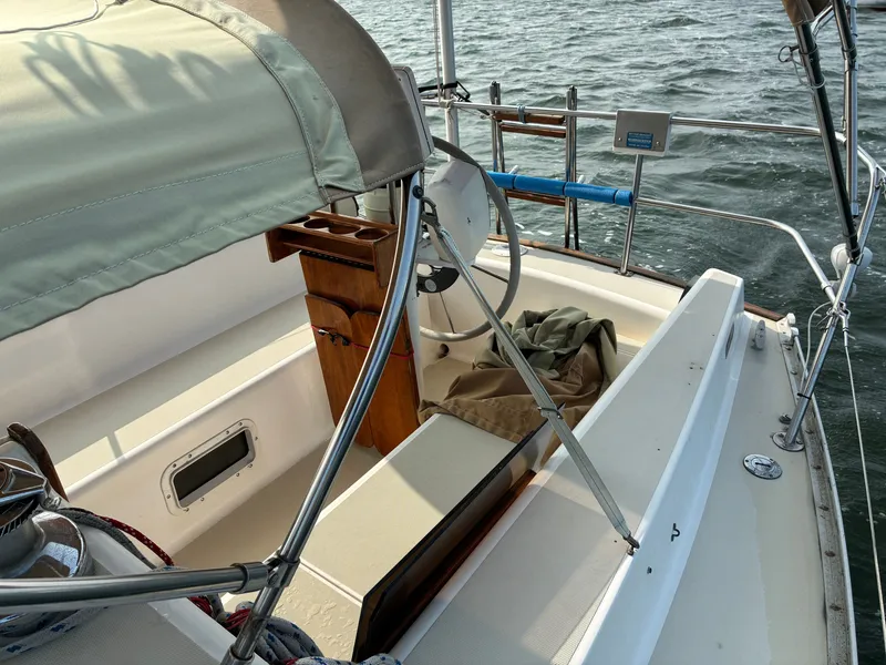Slide: The Image of The cockpit of a 1986 Freedom Yachts 30 with a steering wheel and seating area. - 6