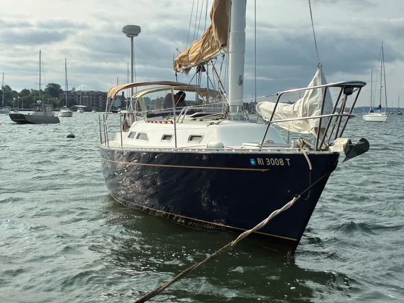 Slide: The Image of A 1986 Freedom Yachts 30 is anchored in the water, surrounded by other boats. - 3