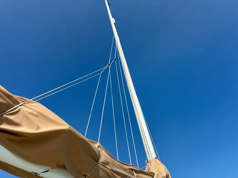 Slide: The Image of The mast of a 1986 Freedom Yachts 30 extends into the clear blue sky. - 21