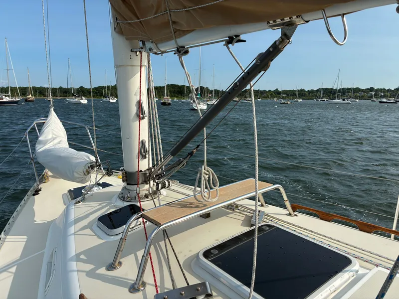 Slide: The Image of A 1986 Freedom Yachts 30 sailboat on the water, surrounded by other boats in the harbor. - 12