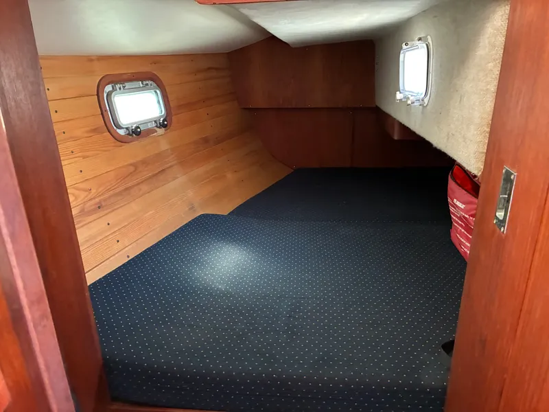 Slide: The Image of Interior of a 1986 Freedom Yachts 30 with wooden walls and dotted carpet flooring. - 36
