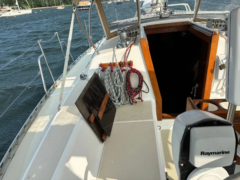 Slide: The Image of The deck of a 1986 Freedom Yachts 30 with ropes and an open companionway. - 9