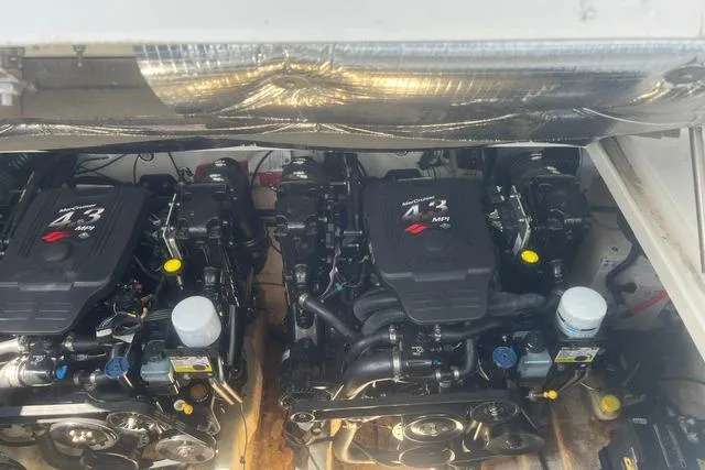 Slide: The Image of Twin engines of a 2006 Sea Ray Sundancer 280 boat, showcasing mechanical components. - 20