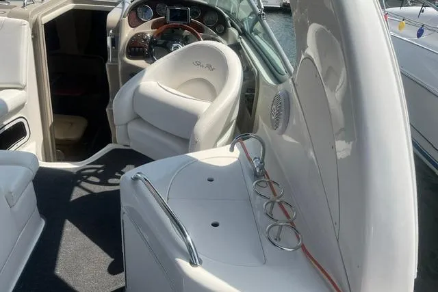 Slide: The Image of 2006 Sea Ray Sundancer 280 interior with helm, seating, and dashboard controls. - 5