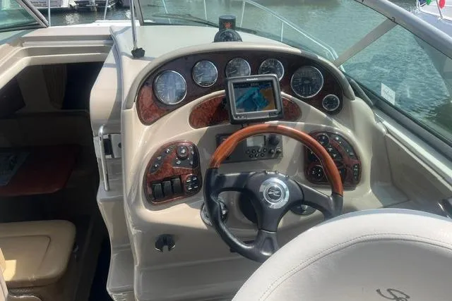 Slide: The Image of 2006 Sea Ray Sundancer 280 helm with wood accents and navigation system. - 6