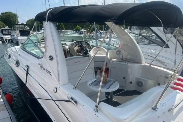 Slide: The Image of 2006 Sea Ray Sundancer 280 boat docked, featuring a spacious cockpit and canopy. - 3