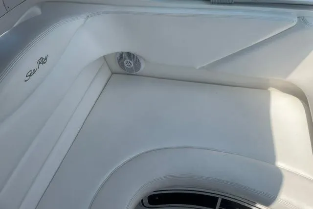Slide: The Image of Interior seating of 2006 Sea Ray Sundancer 280 boat, featuring white upholstery and speaker. - 10