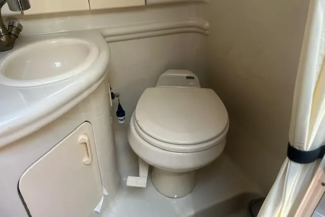 Slide: The Image of Compact bathroom in 2006 Sea Ray Sundancer 280 yacht with toilet and sink. - 19