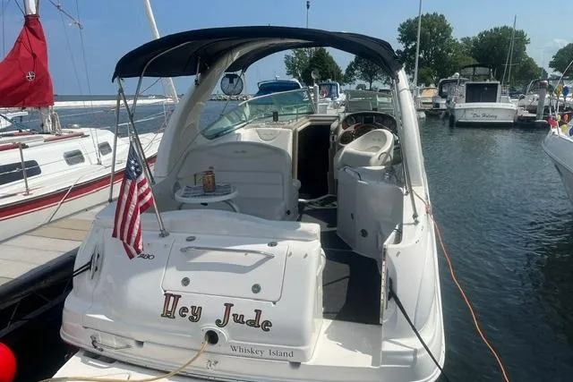Slide: The Image of 2006 Sea Ray Sundancer 280 docked, featuring "Hey Jude" name and American flag. - 2