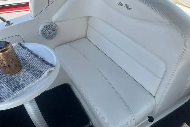 Slide: The Image of 2006 Sea Ray Sundancer 280 interior with white seating and small table. - 11