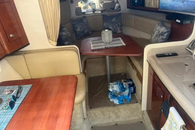 Slide: The Image of Interior of 2006 Sea Ray Sundancer 280 with cozy seating and dining area. - 14