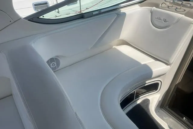 Slide: The Image of Interior seating of 2006 Sea Ray Sundancer 280 boat, featuring white upholstery and sleek design. - 8