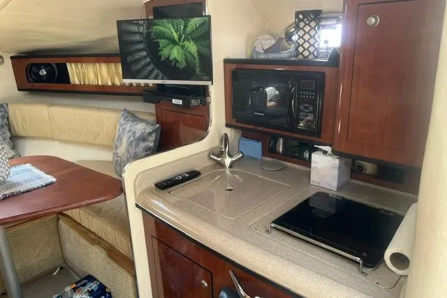 Slide: The Image of Interior of 2006 Sea Ray Sundancer 280 with kitchenette and seating area. - 16