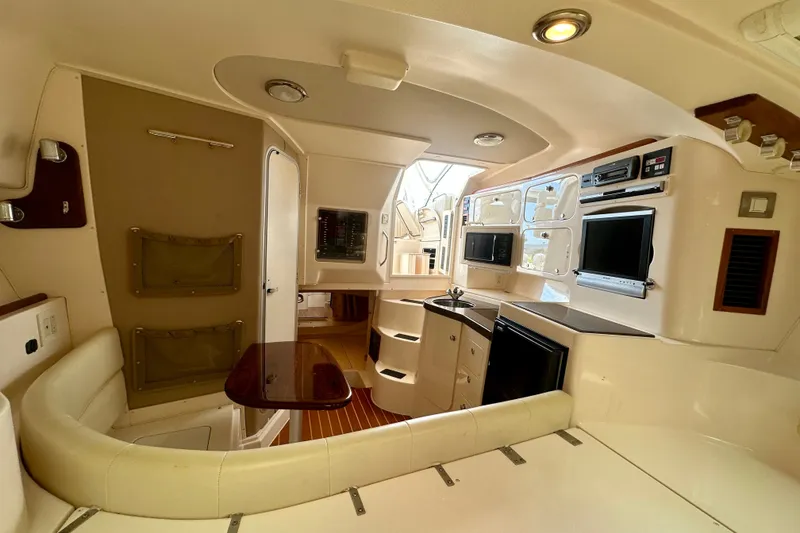 Slide: The Image of Interior of 2007 Grady-White Express 330 boat with kitchenette and seating area. - 93