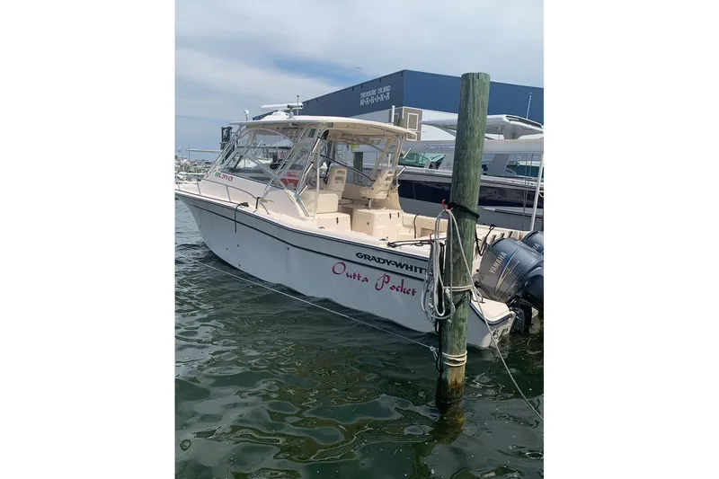 Slide: The Image of 2007 Grady-White Express 330 boat docked, featuring twin Yamaha engines. - 15