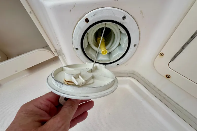 Slide: The Image of Boat fuel cap and hose on a 2007 Grady-White Express 330. - 49