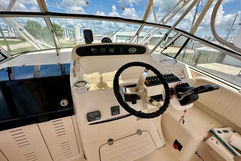 Slide: The Image of Helm of 2007 Grady-White Express 330 boat with steering wheel and controls. - 70