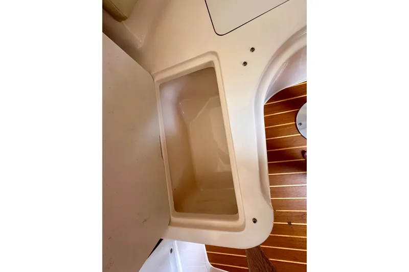 Slide: The Image of Interior view of a 2007 Grady-White Express 330 boat, featuring a storage compartment. - 91
