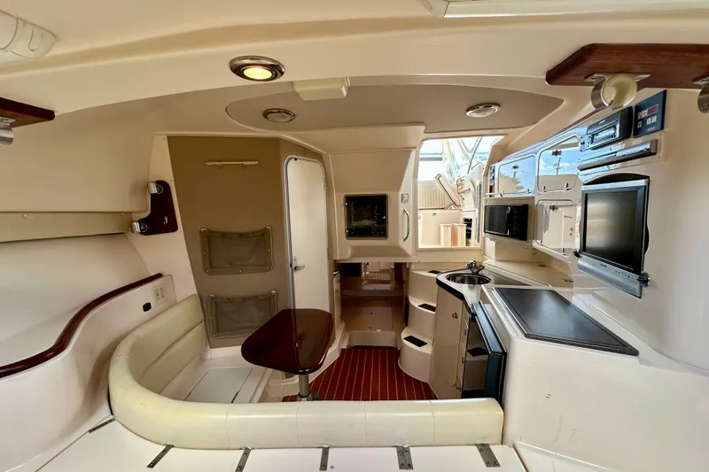 Slide: The Image of Interior of 2007 Grady-White Express 330 boat with seating, kitchenette, and modern amenities. - 95