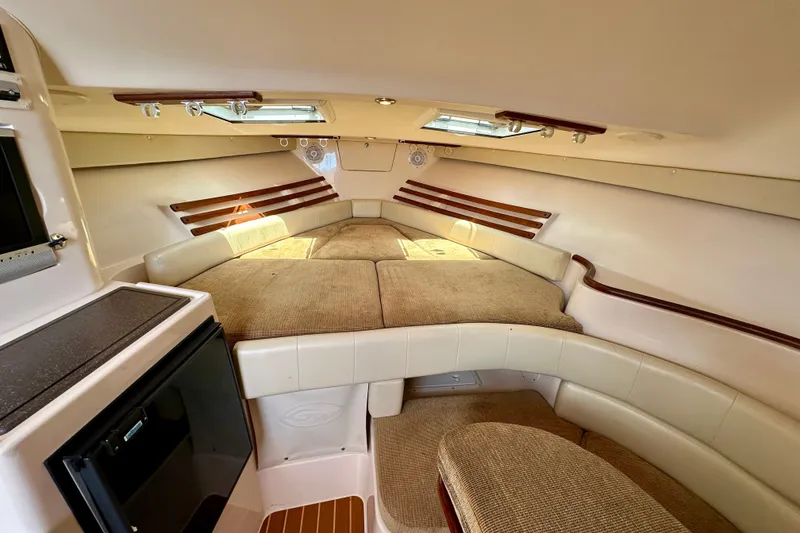 Slide: The Image of Interior cabin of 2007 Grady-White Express 330 boat, featuring cozy seating and natural light. - 21