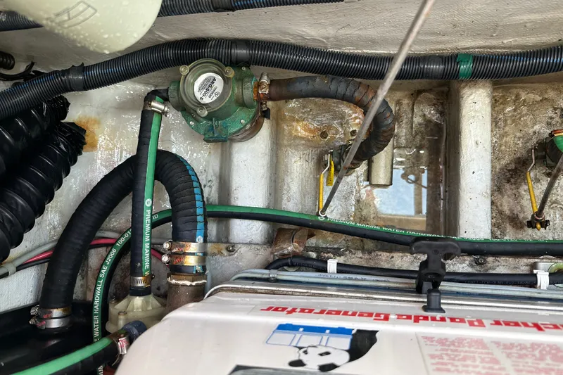 Slide: The Image of Engine compartment of a 2007 Grady-White Express 330 with marine hoses and components. - 116
