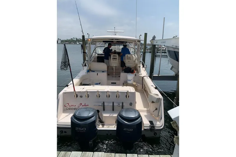 Slide: The Image of 2007 Grady-White Express 330 boat docked, featuring twin 250 horsepower engines. - 16