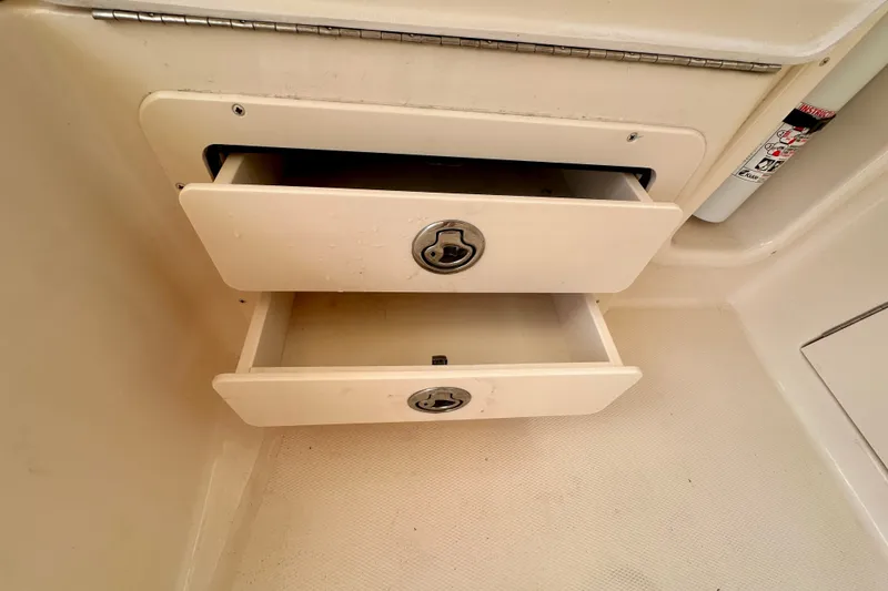 Slide: The Image of Open storage drawers on a 2007 Grady-White Express 330 boat interior. - 59