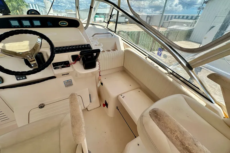 Slide: The Image of 2007 Grady-White Express 330 boat cockpit with steering wheel and seating area. - 63