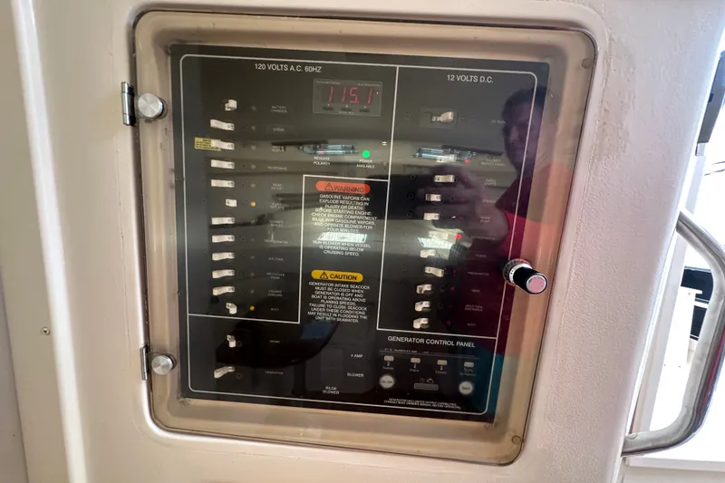 Slide: The Image of Electrical control panel on a 2007 Grady-White Express 330 boat. - 77