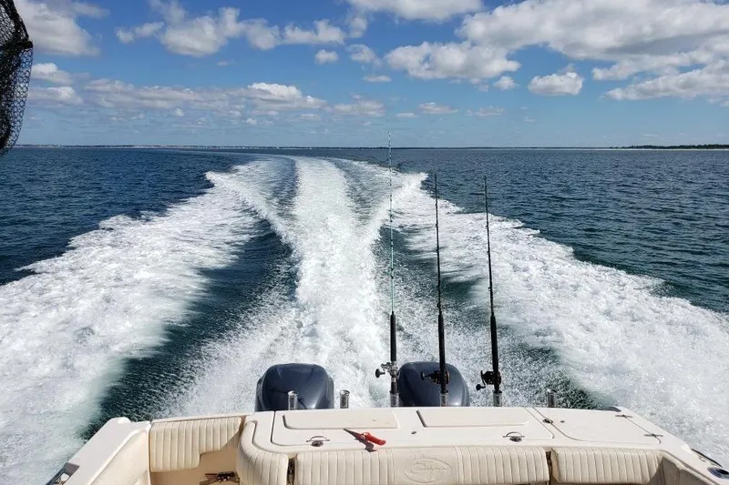 Slide: The Image of 2007 Grady-White Express 330 boat cruising on open water with fishing rods. - 17