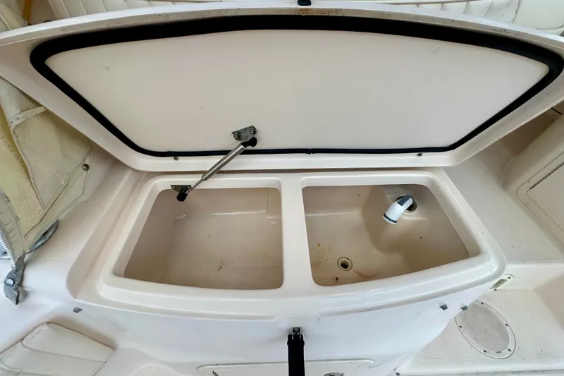 Slide: The Image of 2007 Grady-White Express 330 boat sink with dual compartments and open lid. - 53