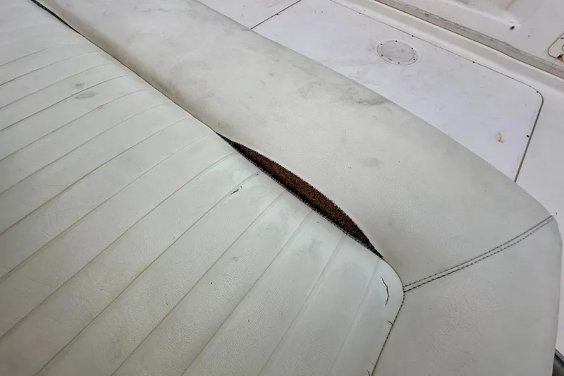 Slide: The Image of Worn seat upholstery on a 2007 Grady-White Express 330 boat, showing visible damage. - 43