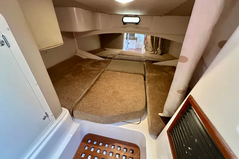 Slide: The Image of 2007 Grady-White Express 330 cabin interior with cozy sleeping area and soft cushions. - 23