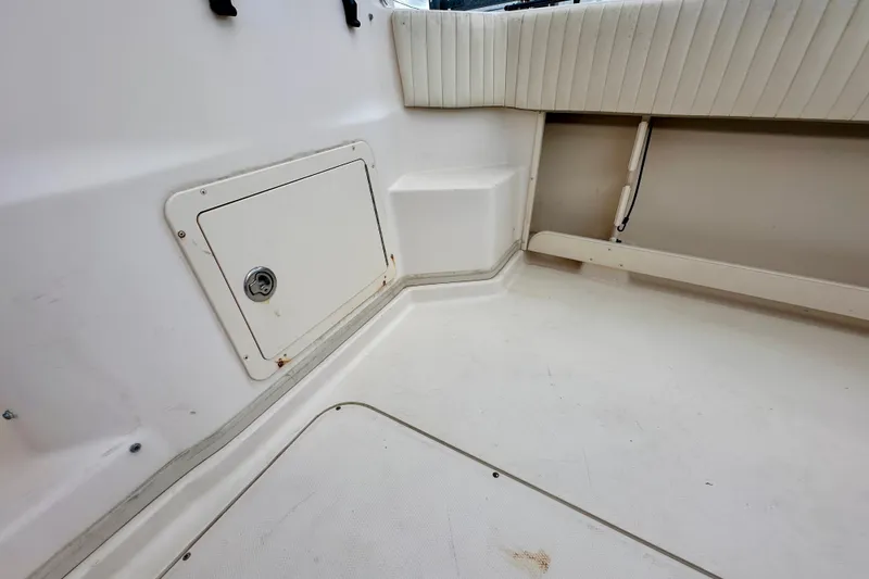 Slide: The Image of 2007 Grady-White Express 330 boat interior, featuring storage compartment and cushioned seating. - 44